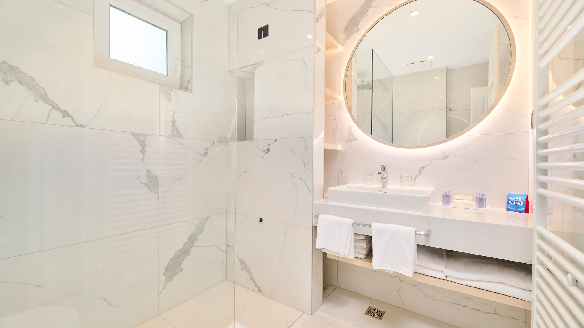 a bathroom with a round mirror