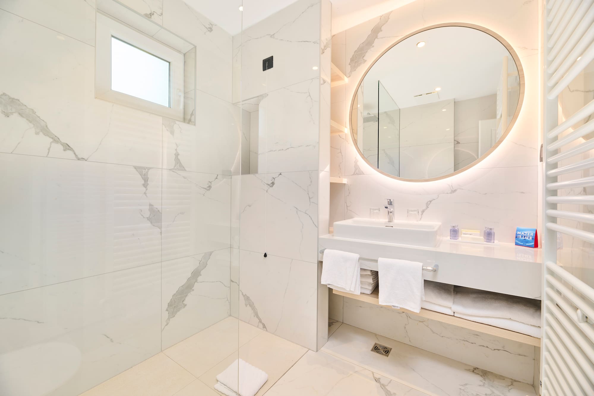 a bathroom with a round mirror