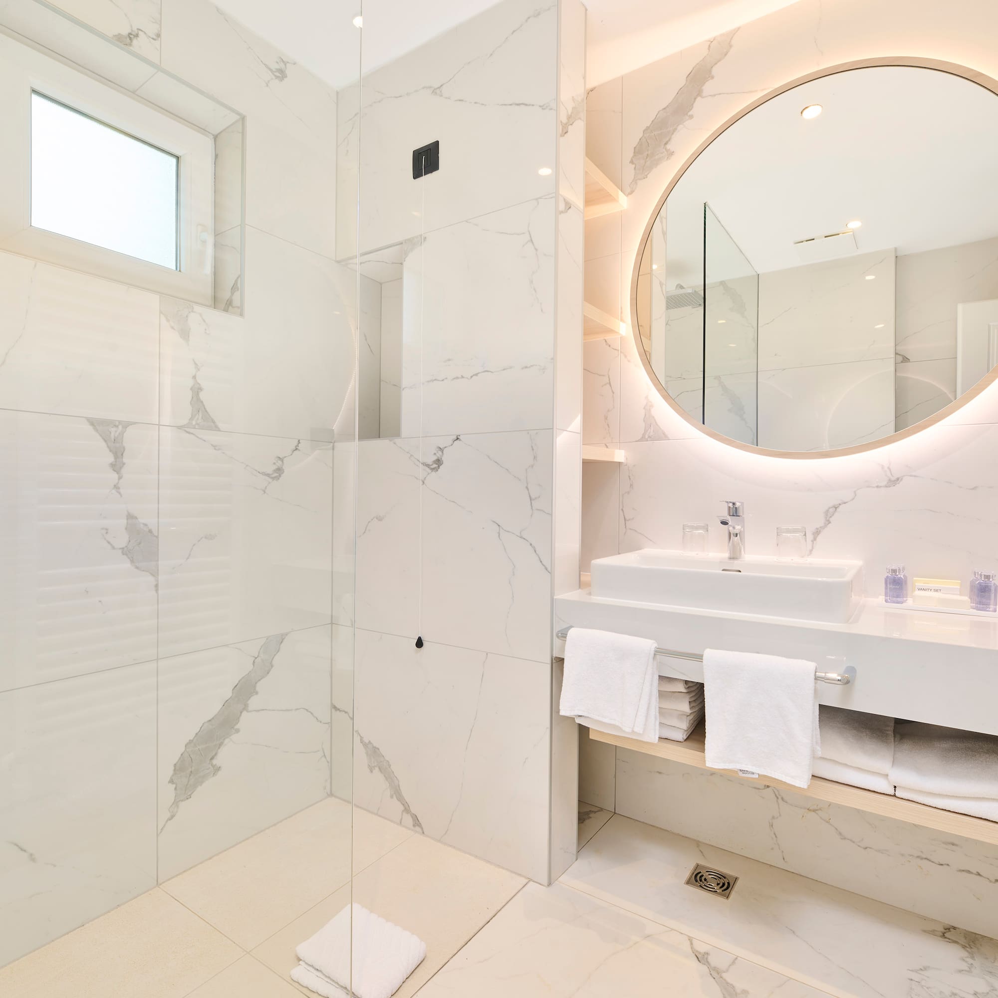 a bathroom with a round mirror