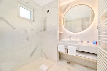 a bathroom with a round mirror