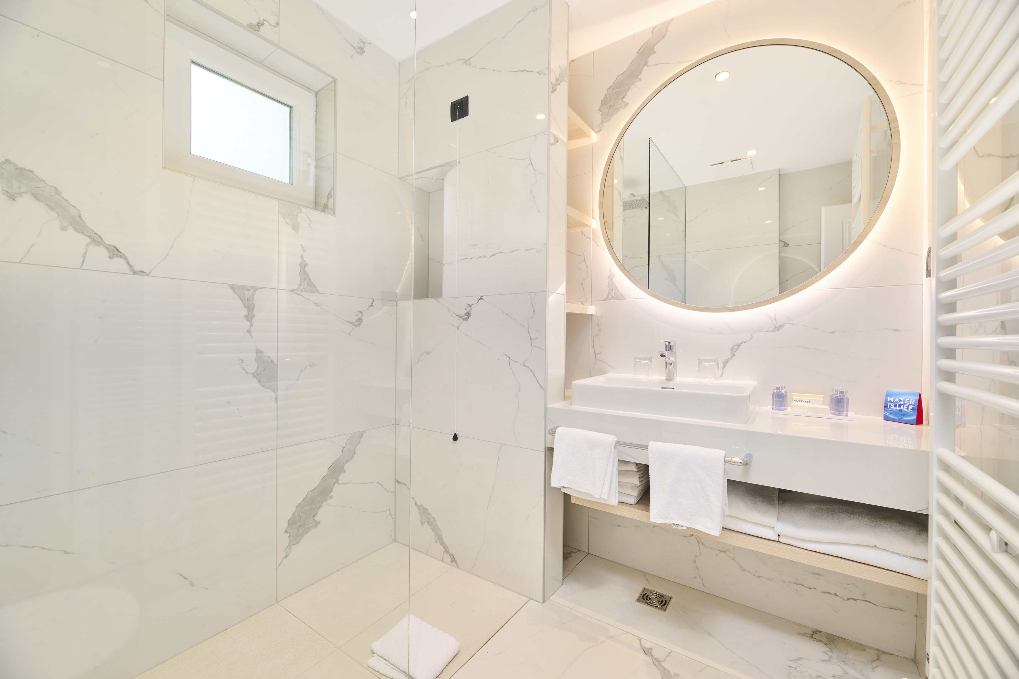 a bathroom with a round mirror