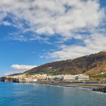 a beach with buildings and a body of water