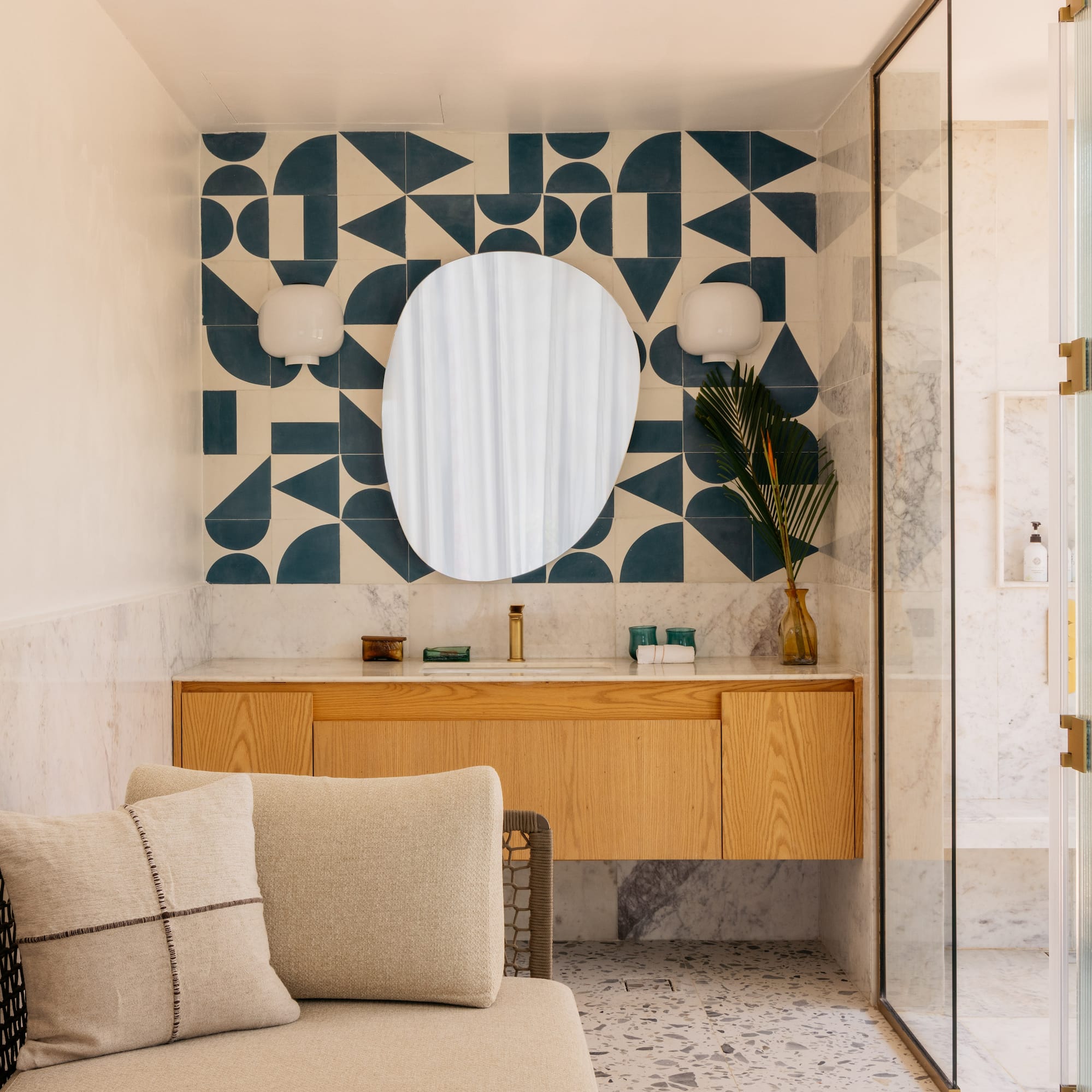 a bathroom with a mirror and a couch