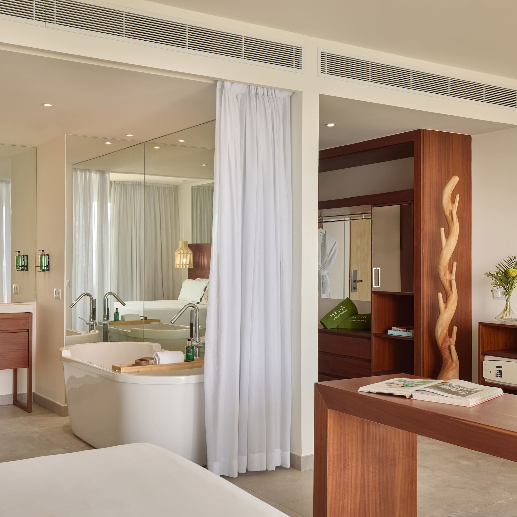 a room with a bathtub and a mirror