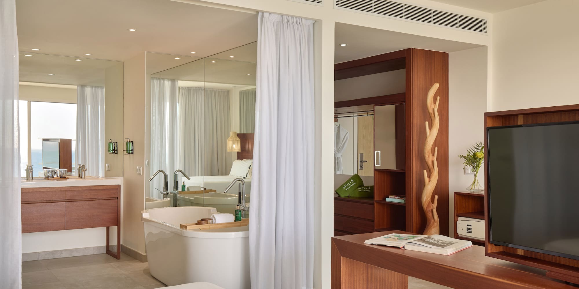 a room with a bathtub and a mirror