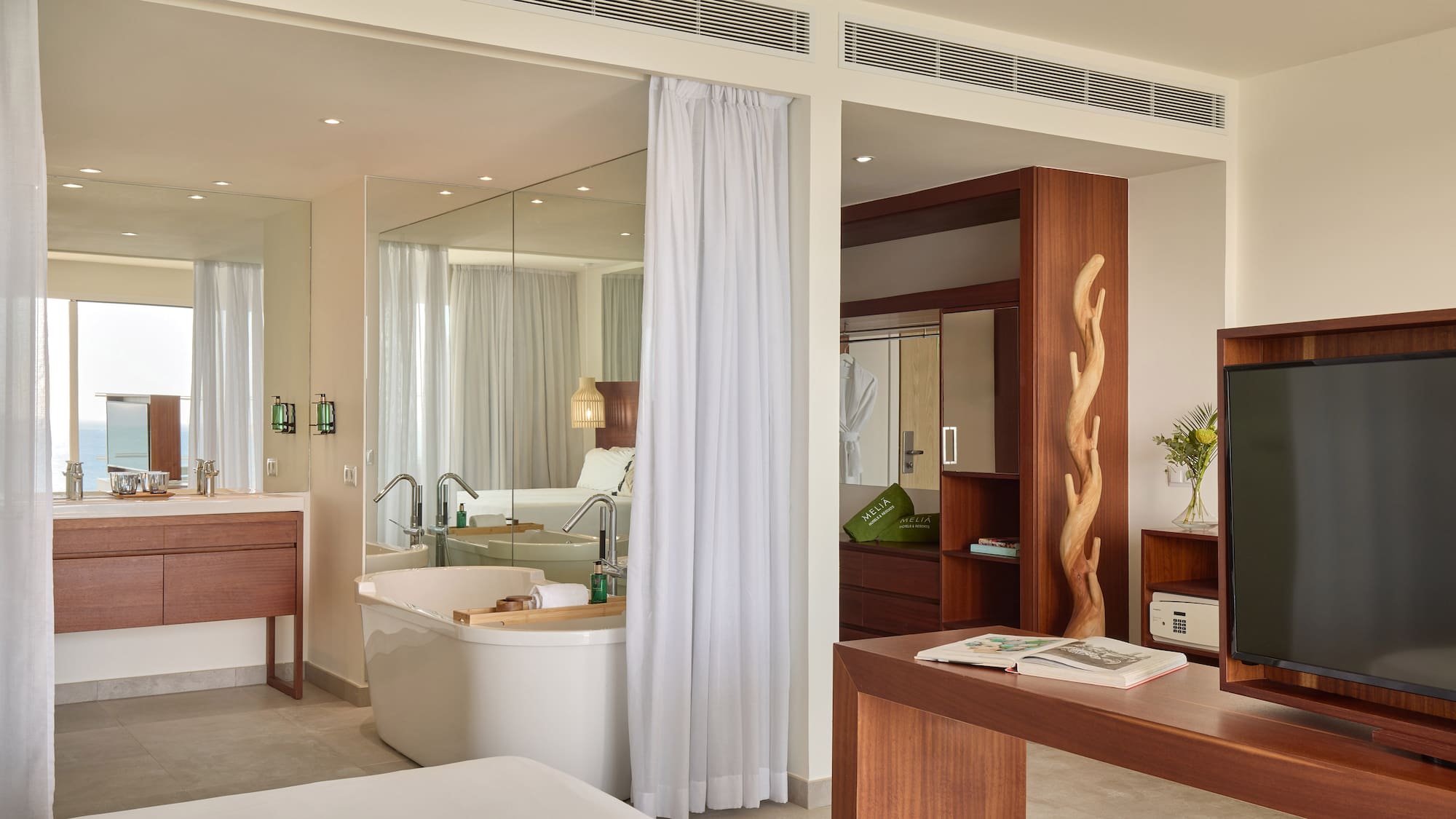 a room with a bathtub and a mirror