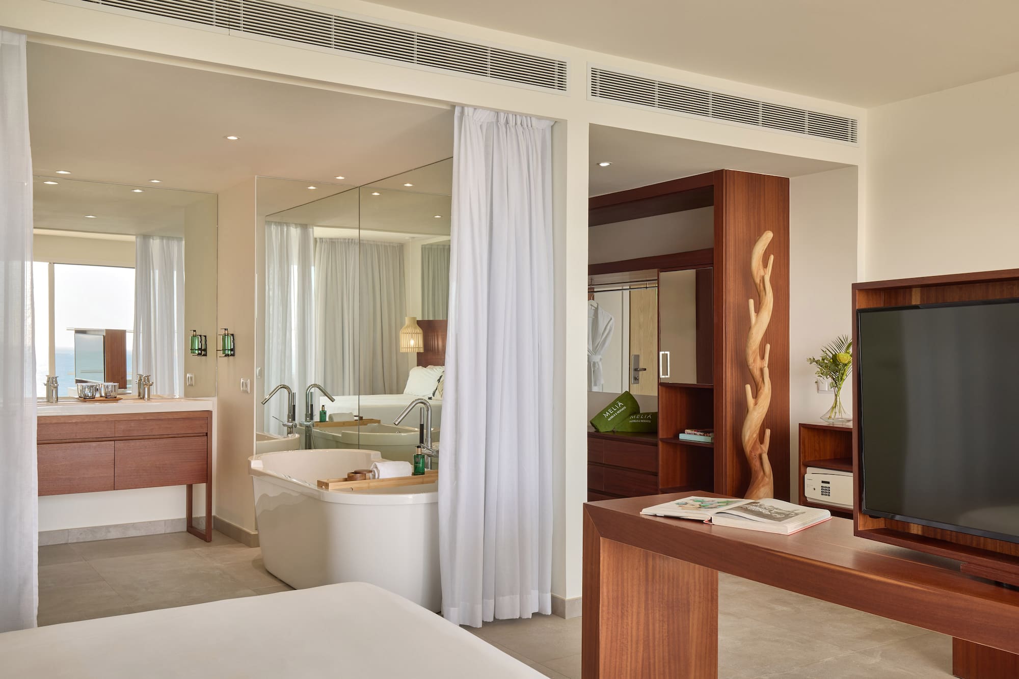 a room with a bathtub and a mirror