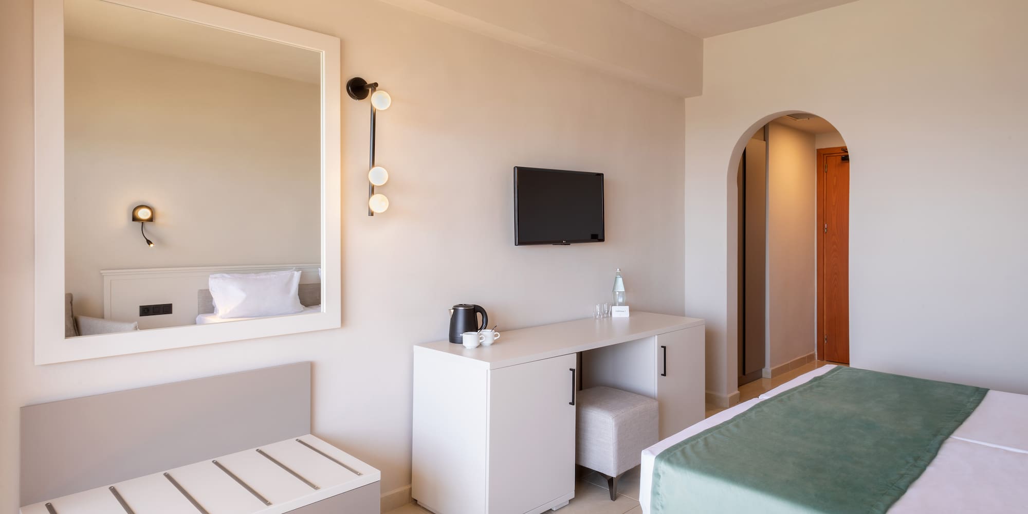 a bedroom with a mirror and a bed