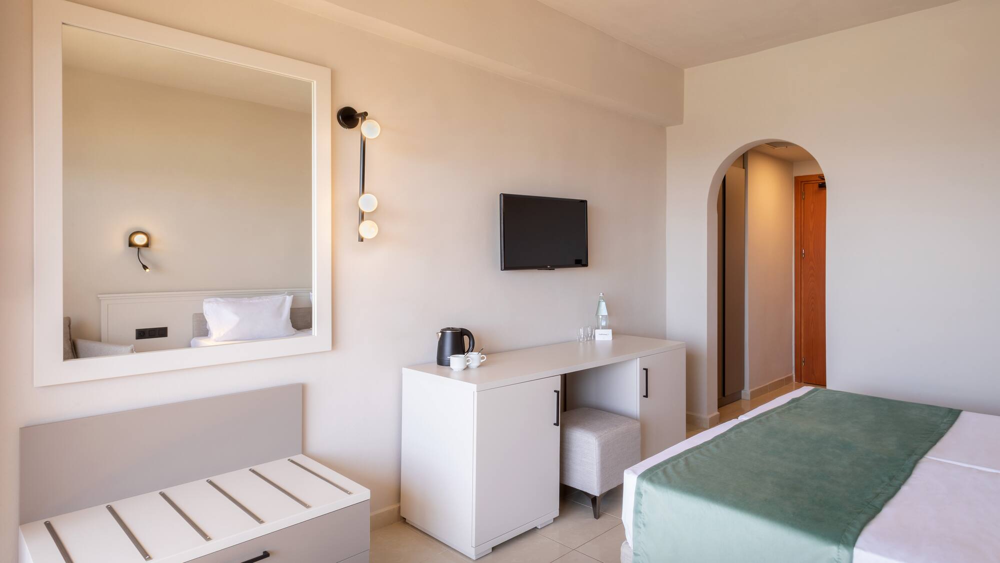 a bedroom with a mirror and a bed