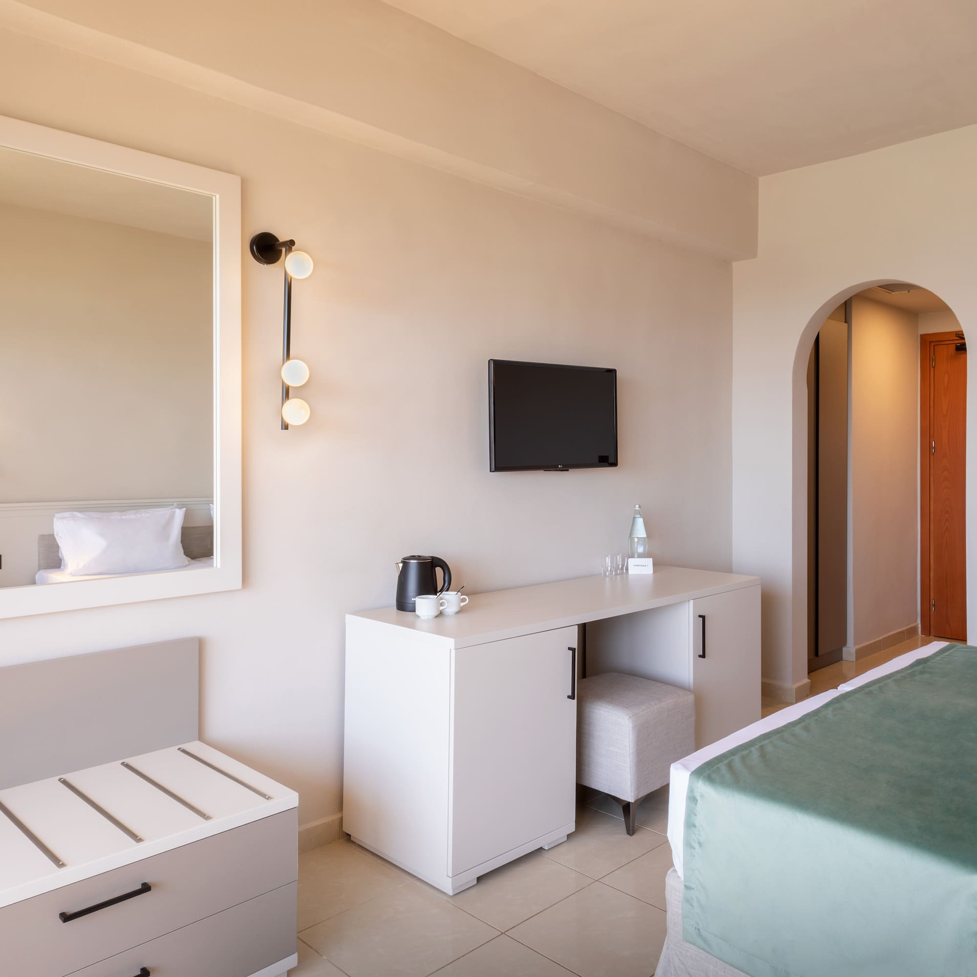 a bedroom with a mirror and a bed