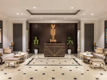 a room with a reception desk and chairs