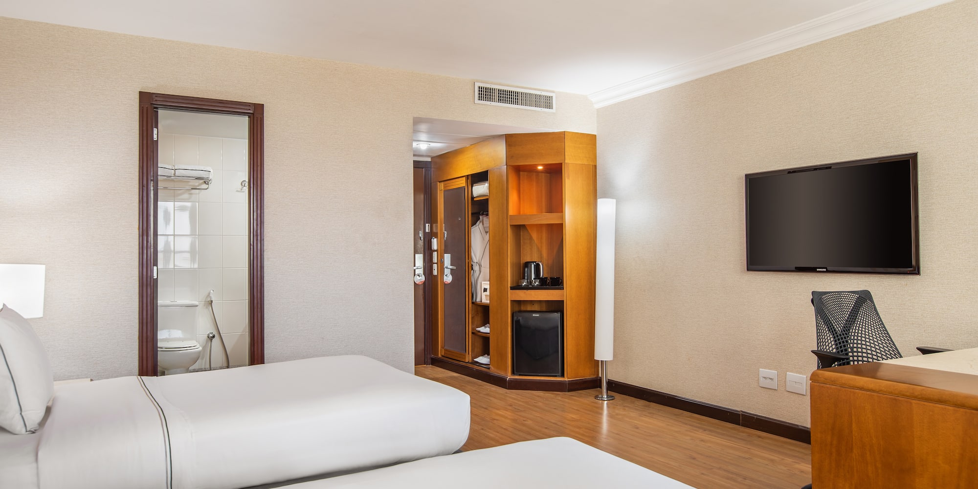 a room with two beds and a television