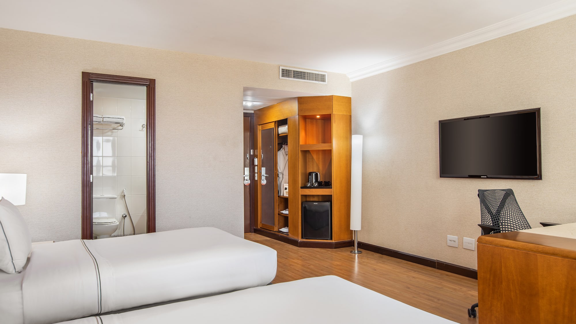 a room with two beds and a television