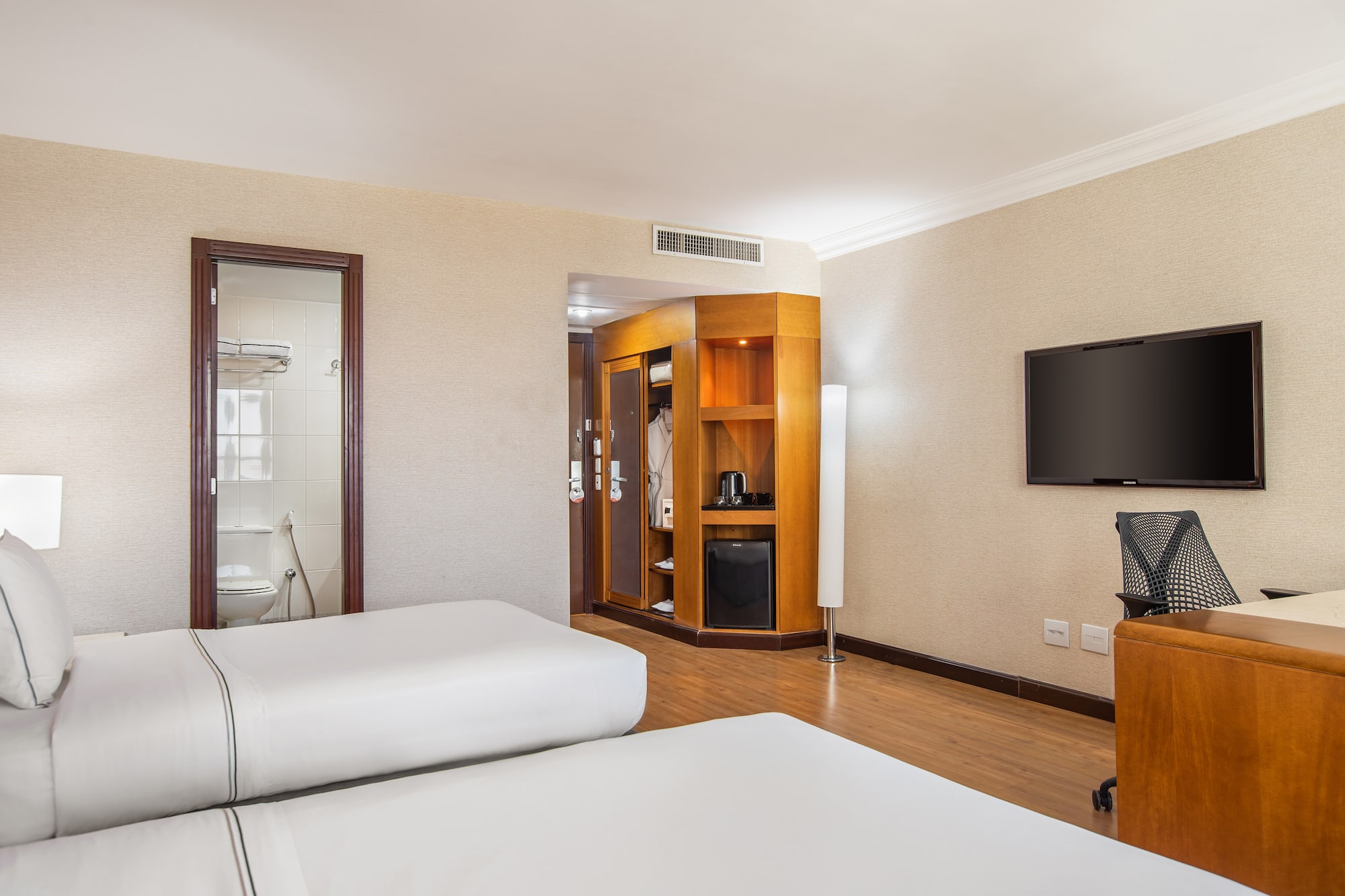 a room with two beds and a television