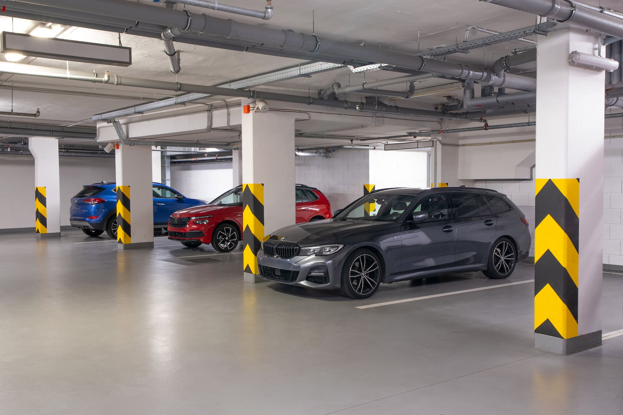 a group of cars parked in a parking garage