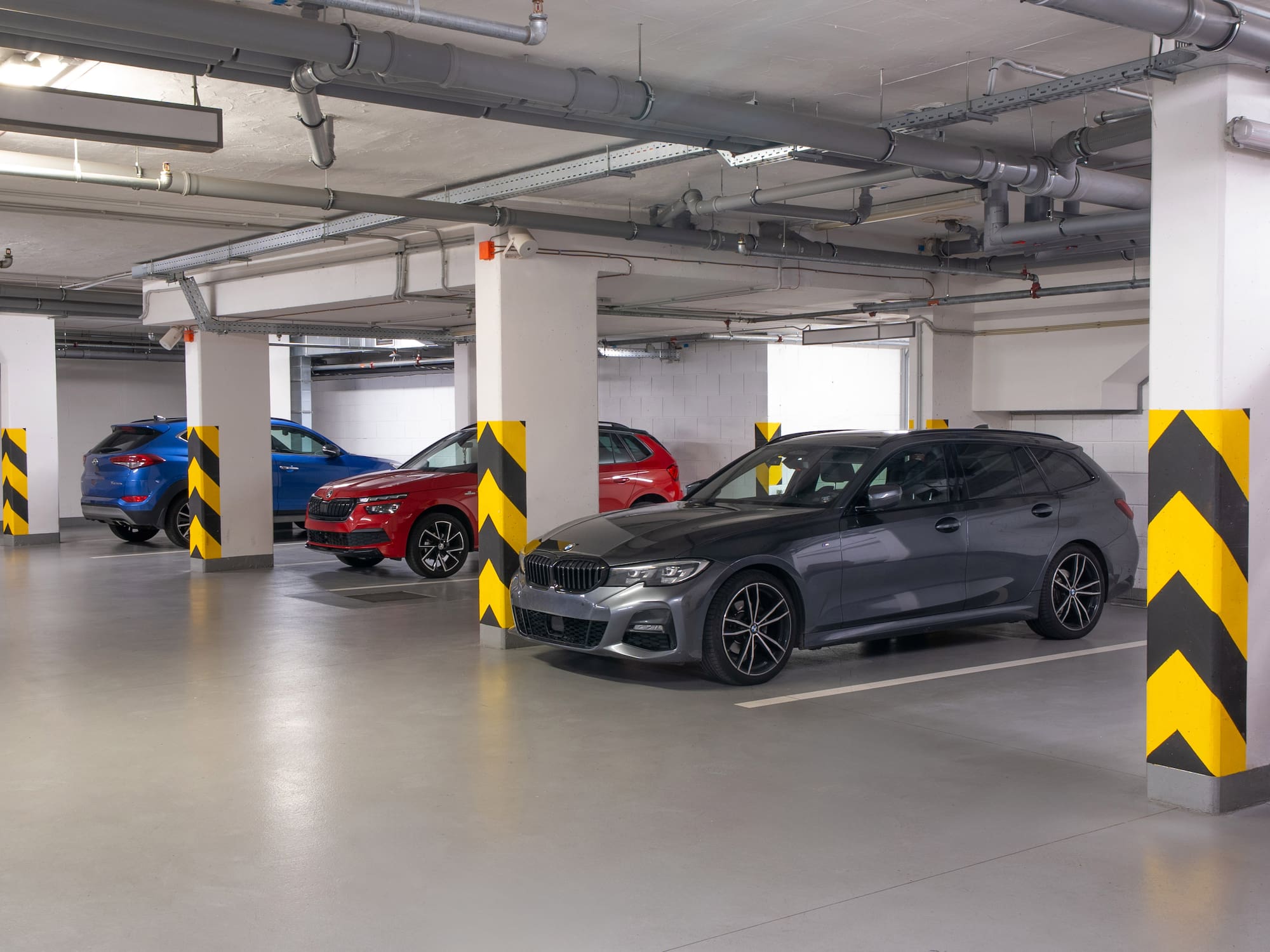a group of cars parked in a parking garage