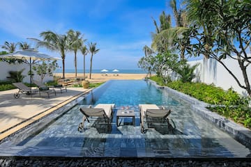 a pool with chairs and a table on it