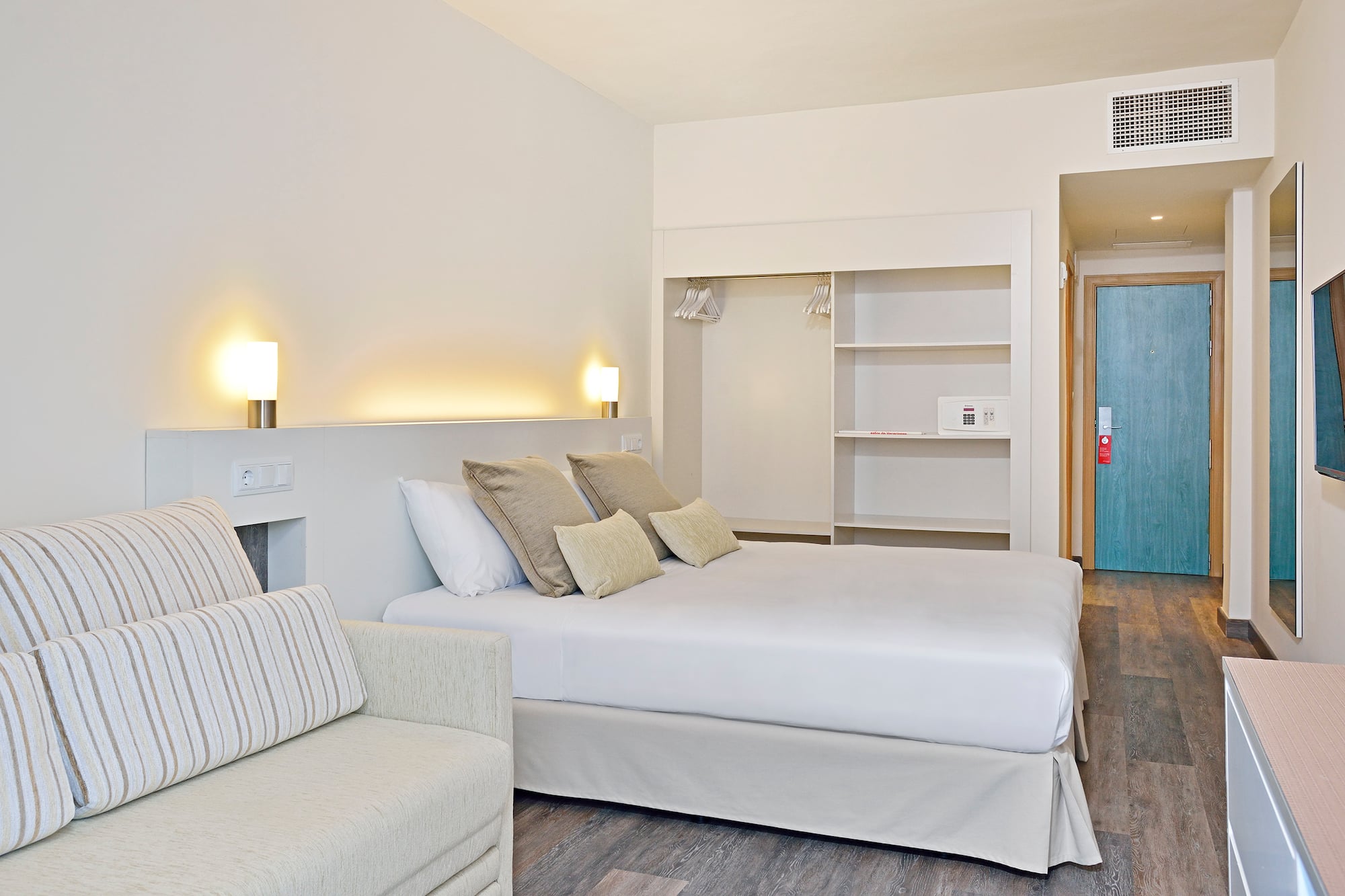 a bedroom with a bed and a couch