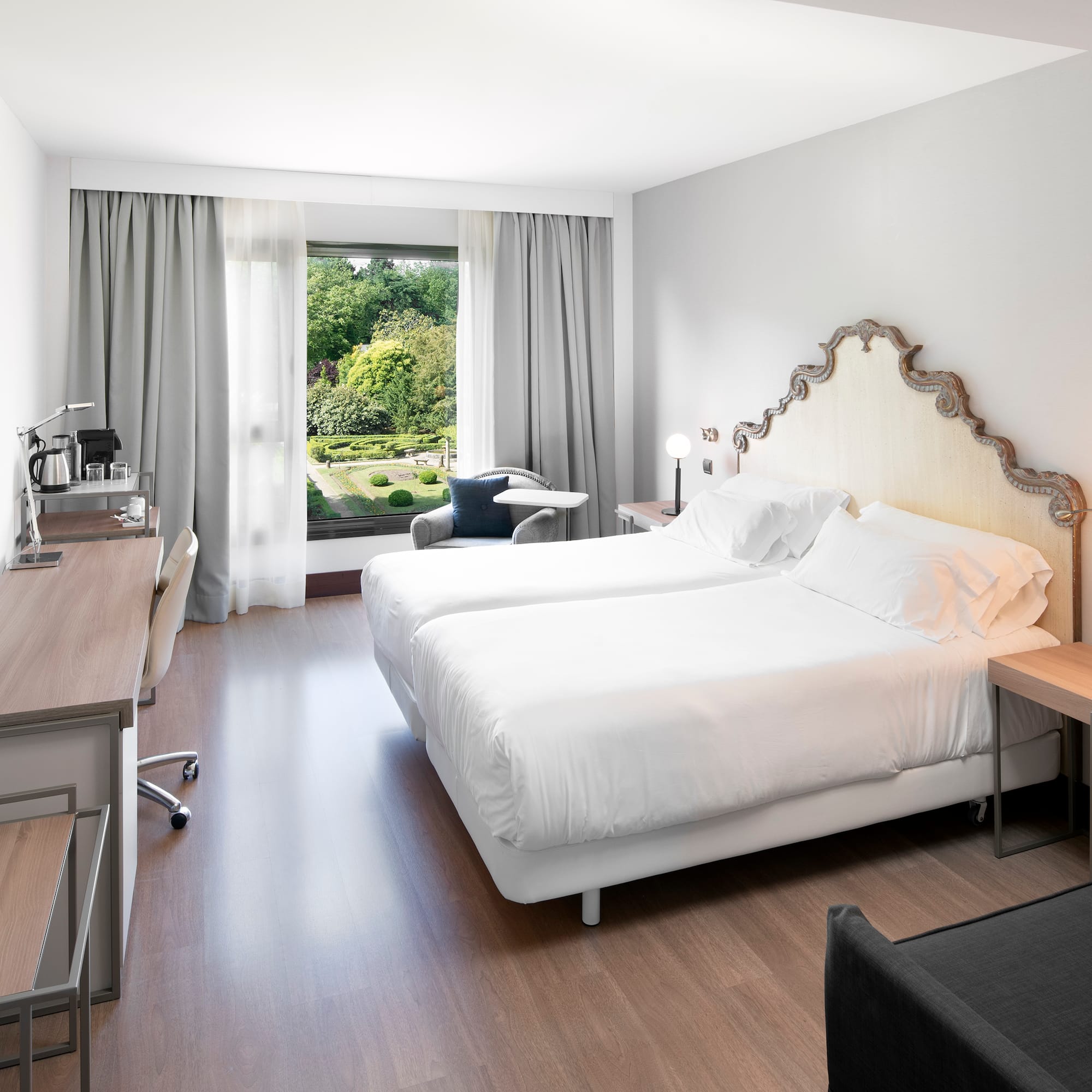 a room with two beds and a desk