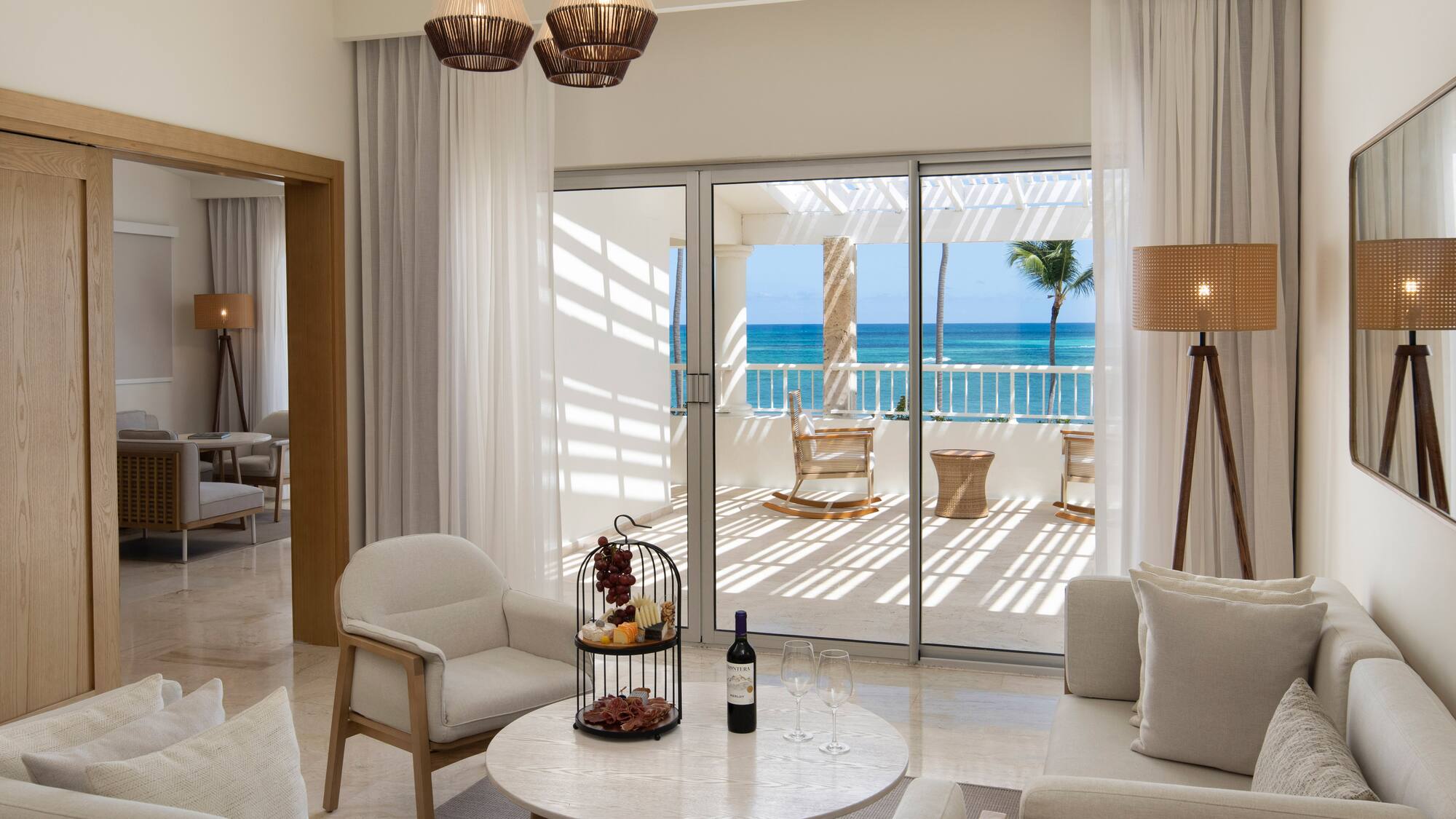 a room with a glass door and a table with a wine bottle