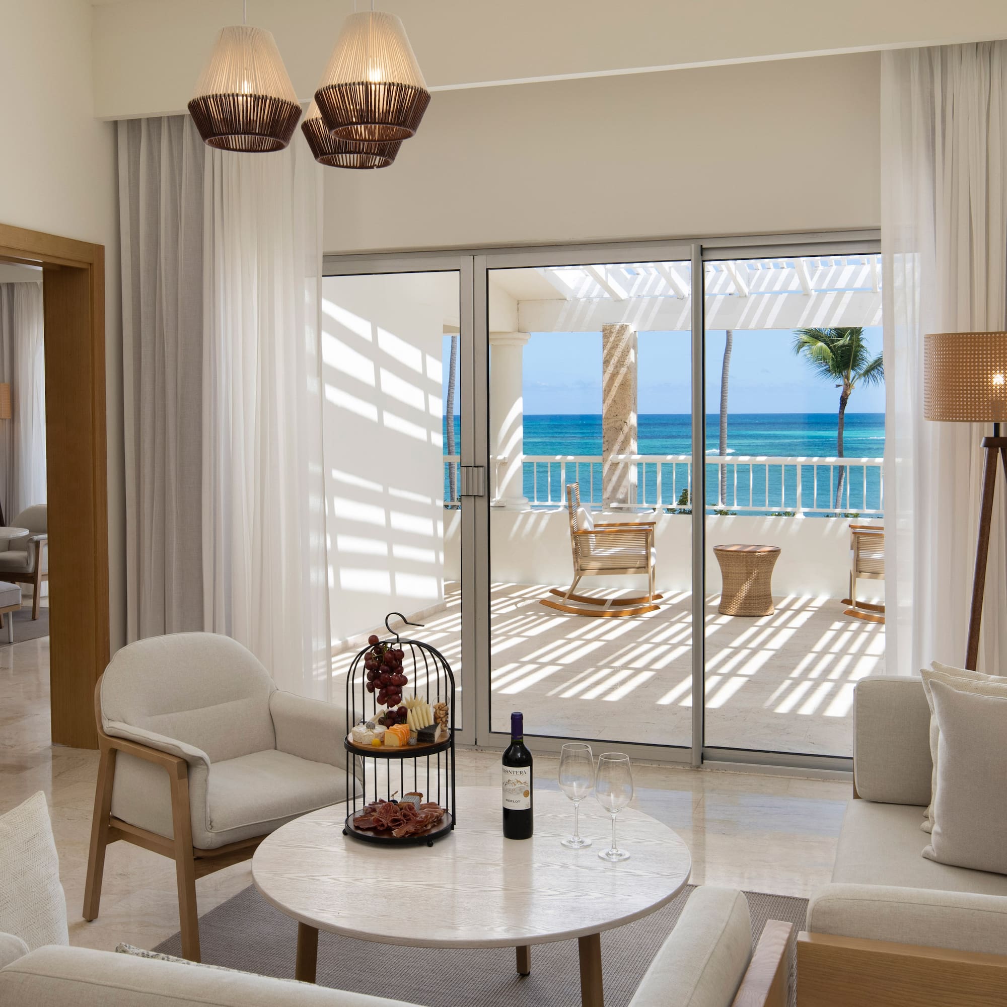 a room with a glass door and a table with a wine bottle