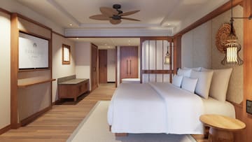 a bedroom with a white bed and a wood floor