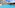 Tropical resort with spacious blue pool, hotel building, and palm trees.