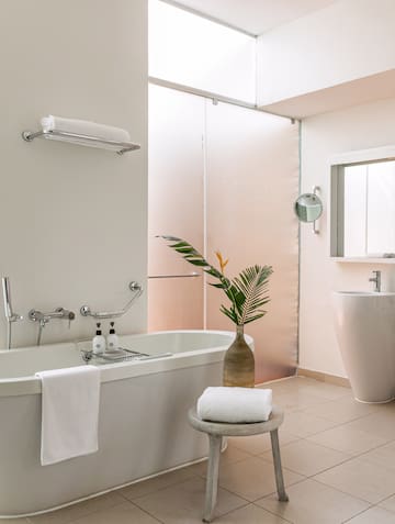 a bathroom with a tub and toilet