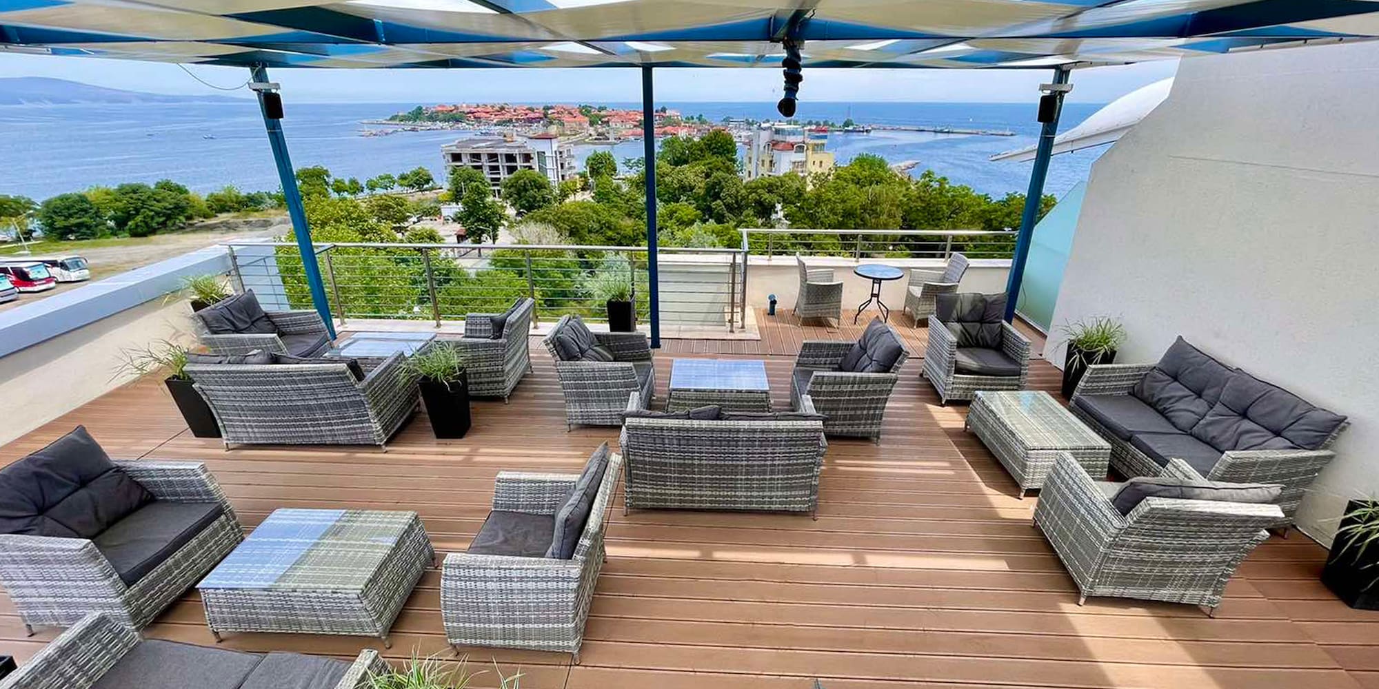 a patio area with chairs and a view of the ocean