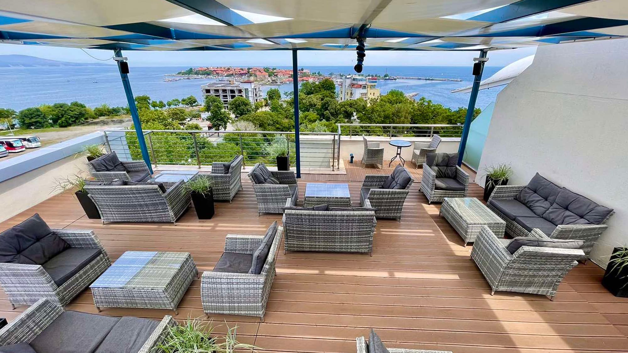 a patio area with chairs and a view of the ocean