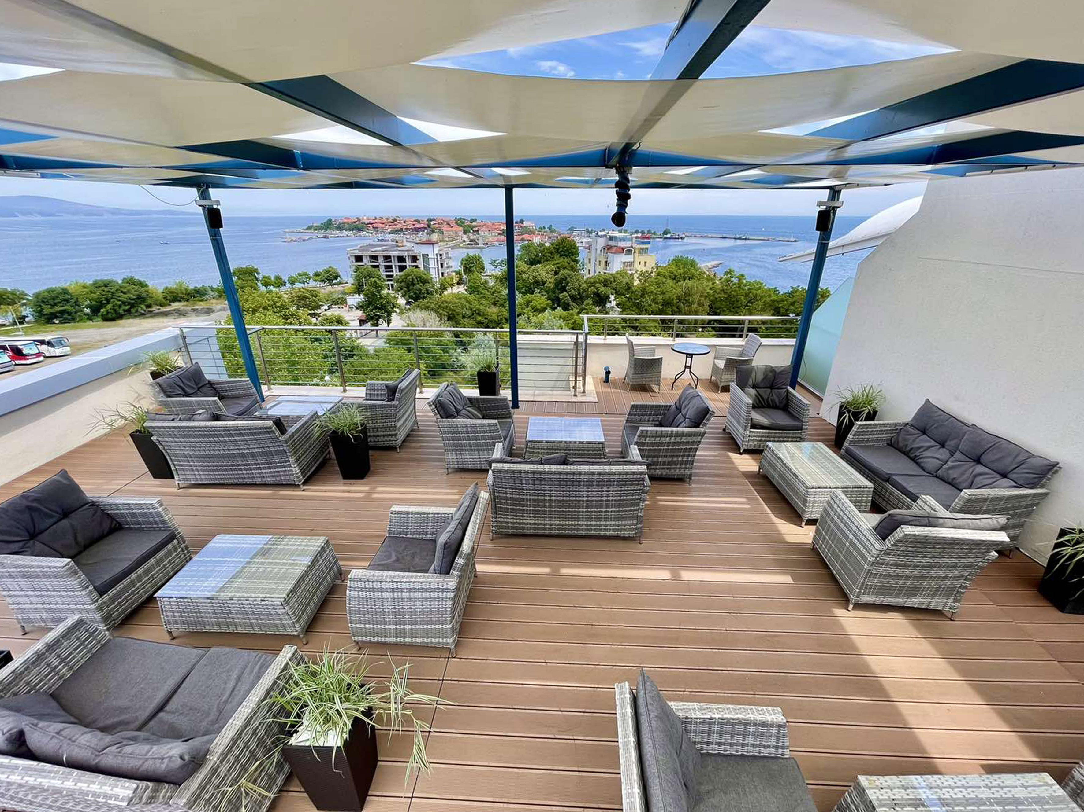 a patio area with chairs and a view of the ocean