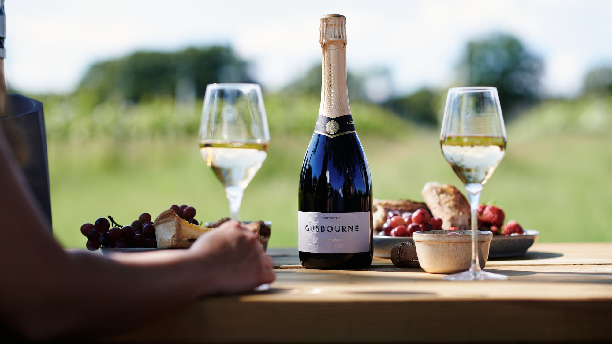 a bottle of wine and glasses on a table