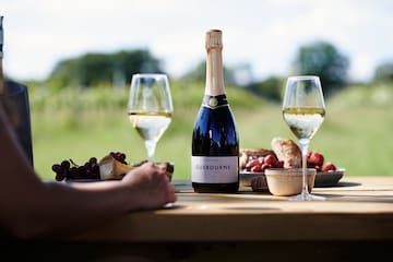 a bottle of wine and glasses on a table