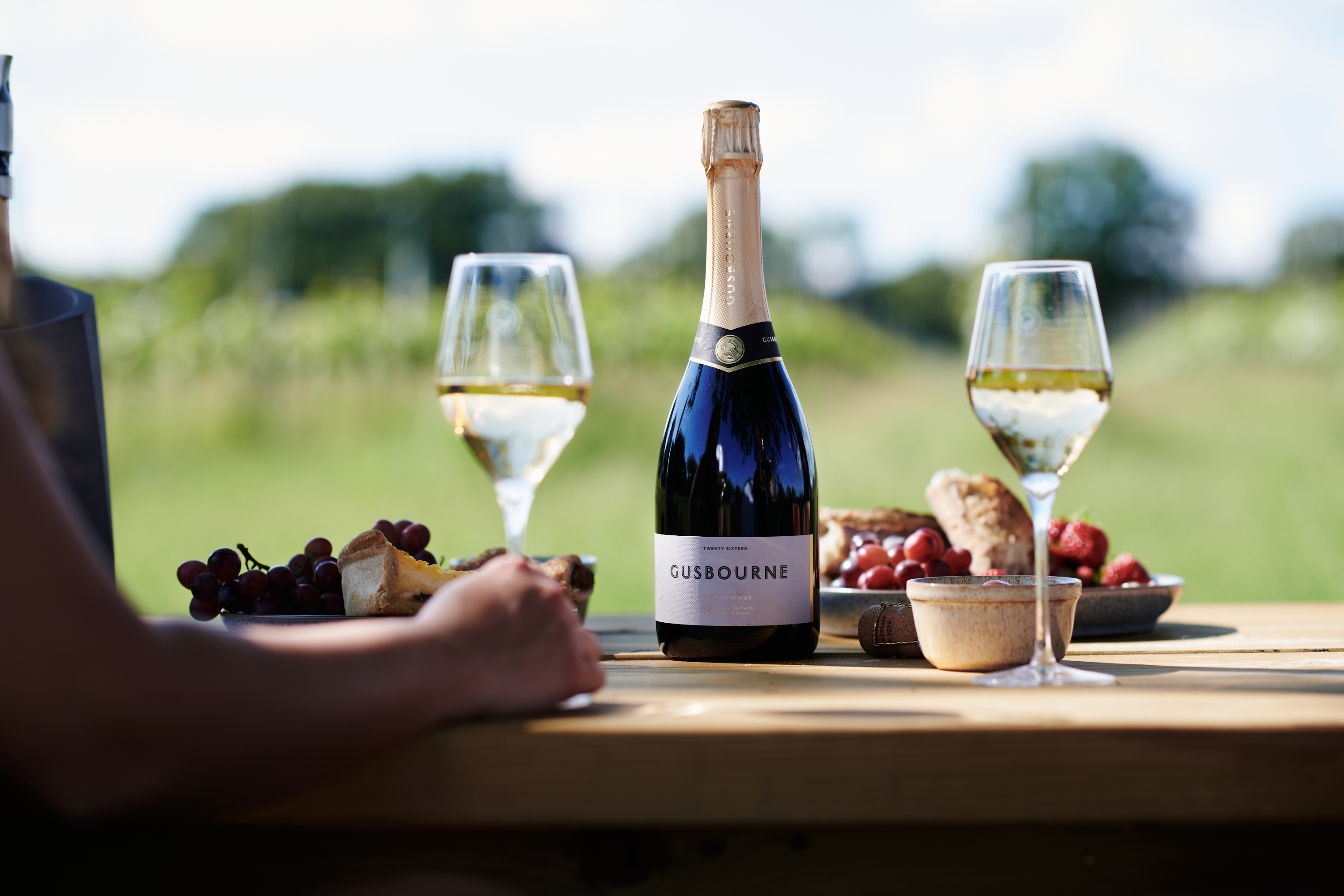a bottle of wine and glasses on a table