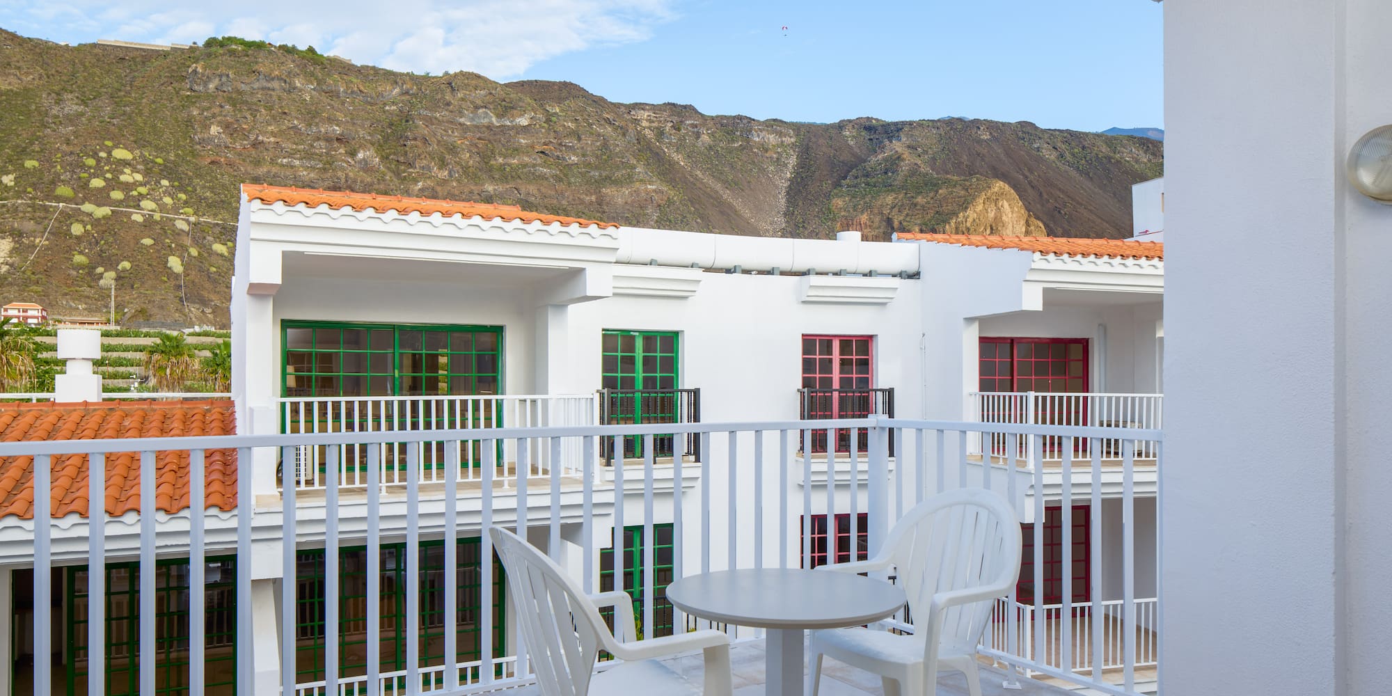 a balcony with a table and chairs