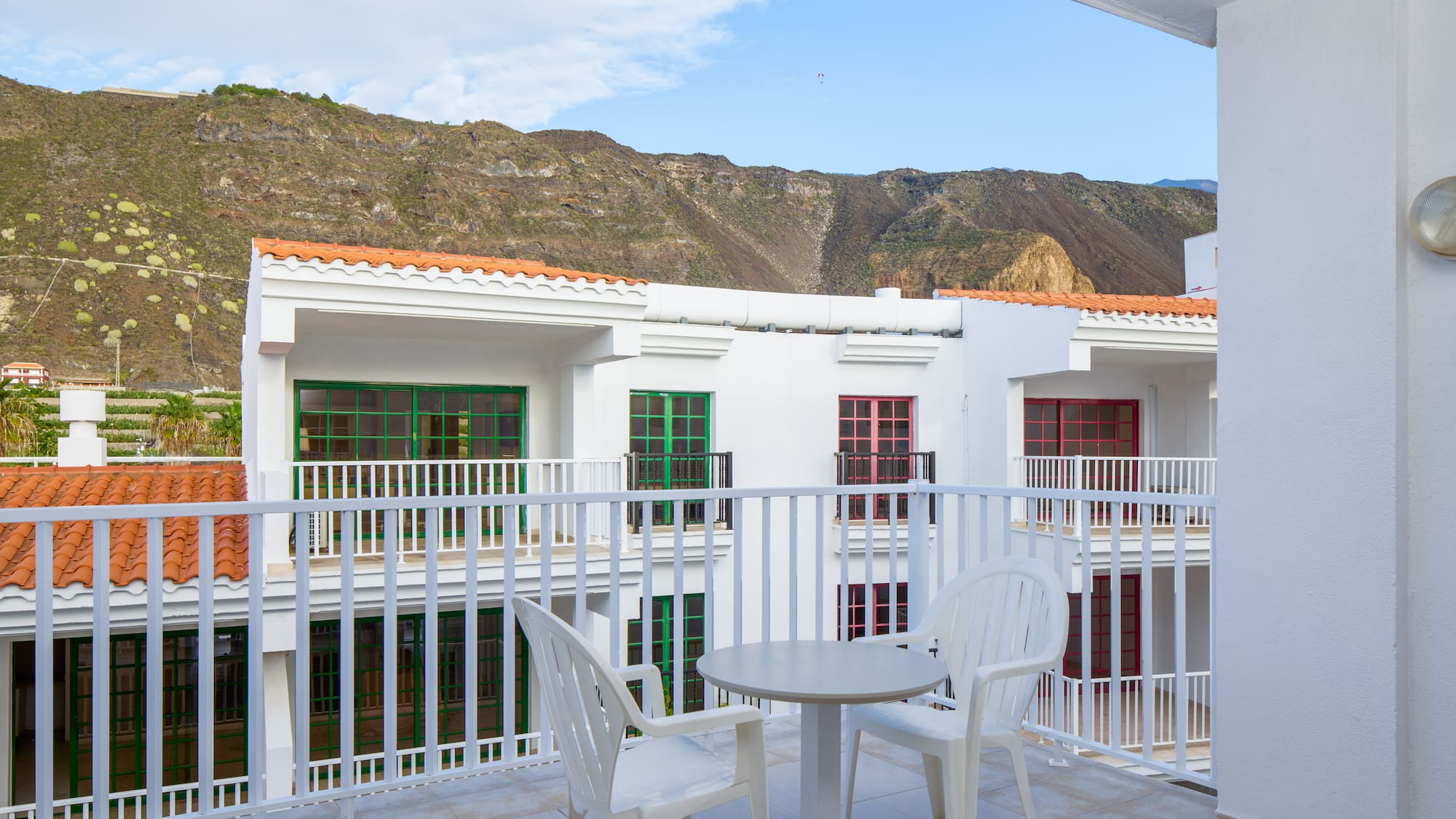 a balcony with a table and chairs