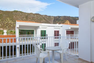 a balcony with a table and chairs