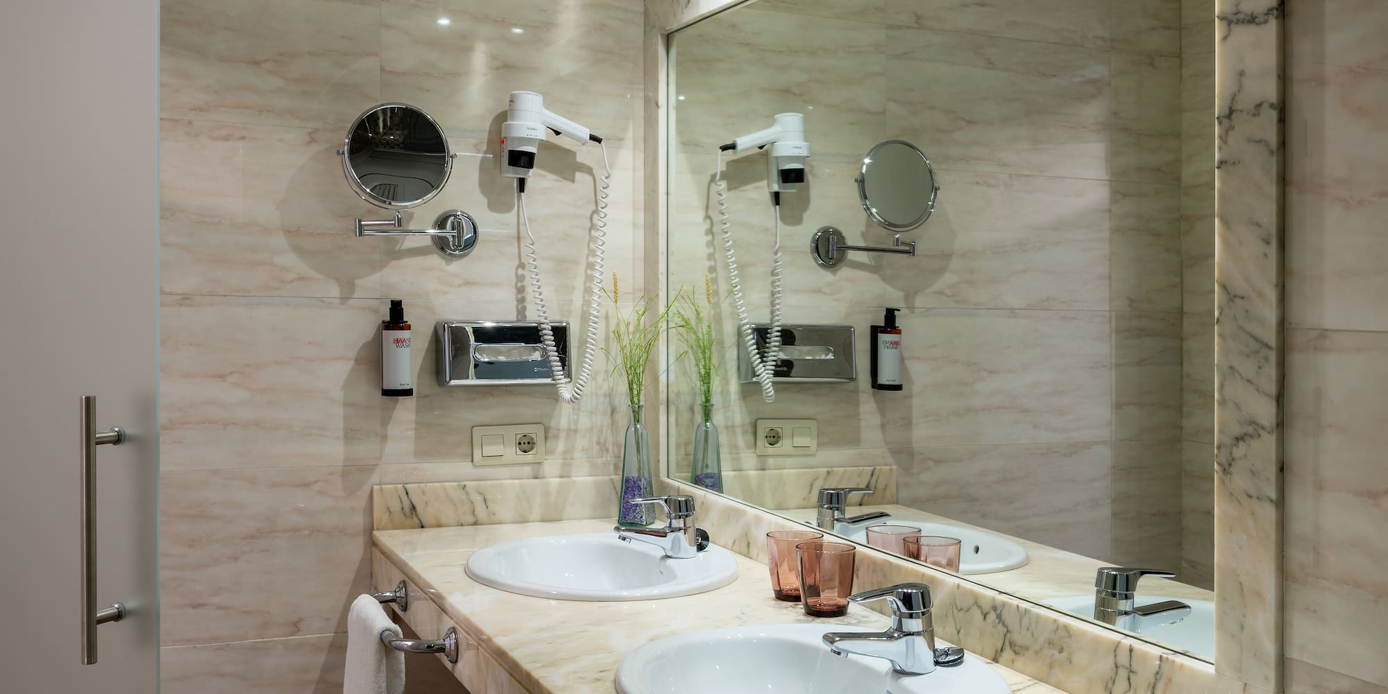 a bathroom with a large mirror and sinks