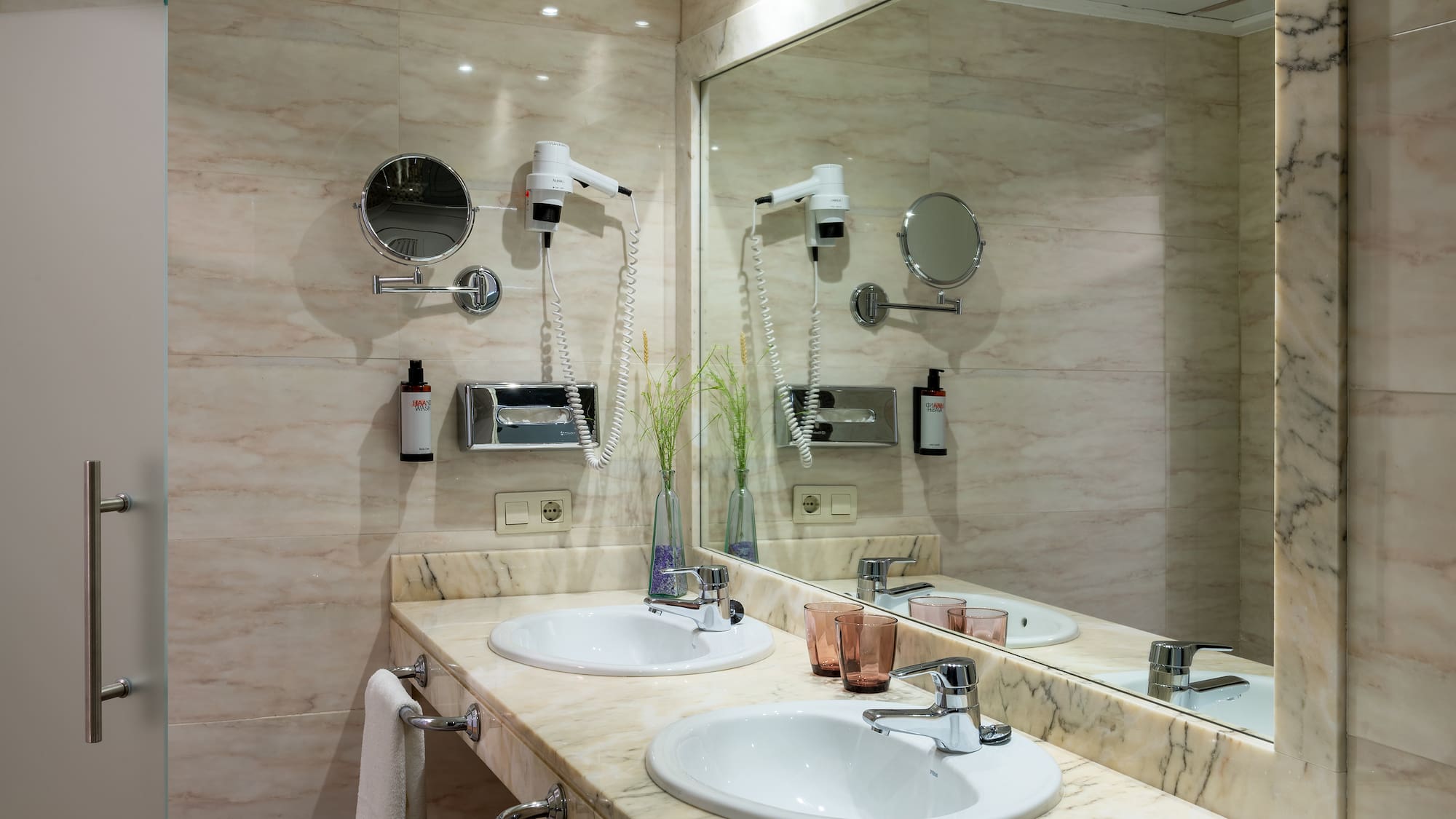 a bathroom with a large mirror and sinks