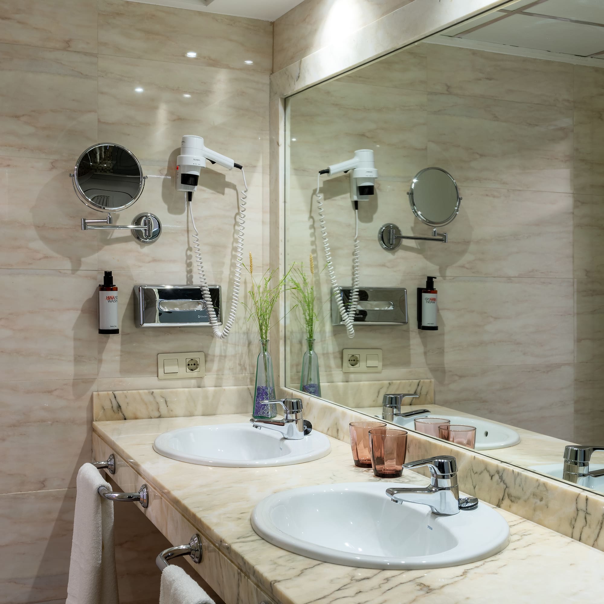 a bathroom with a large mirror and sinks