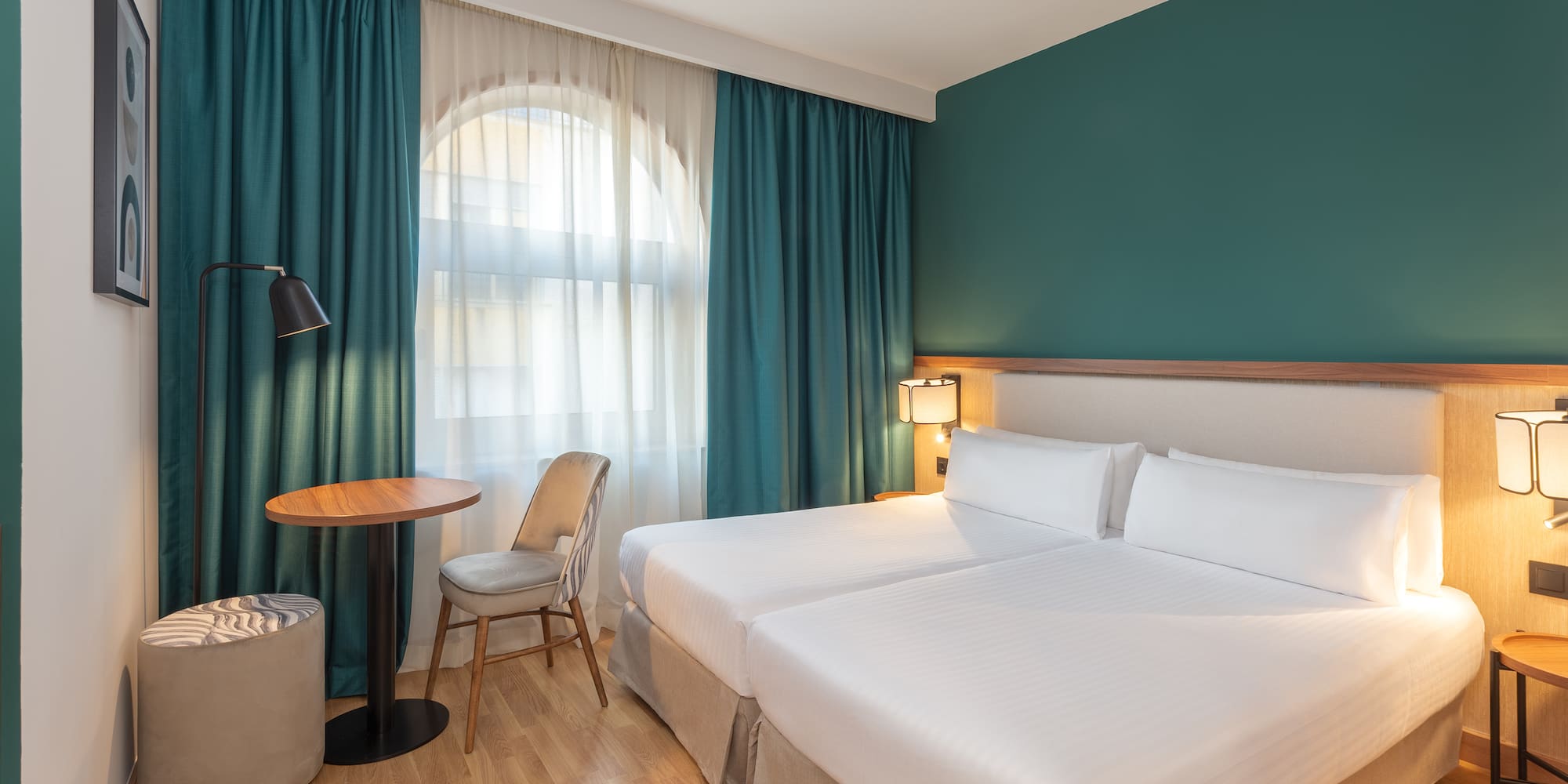 a hotel room with a table and chairs