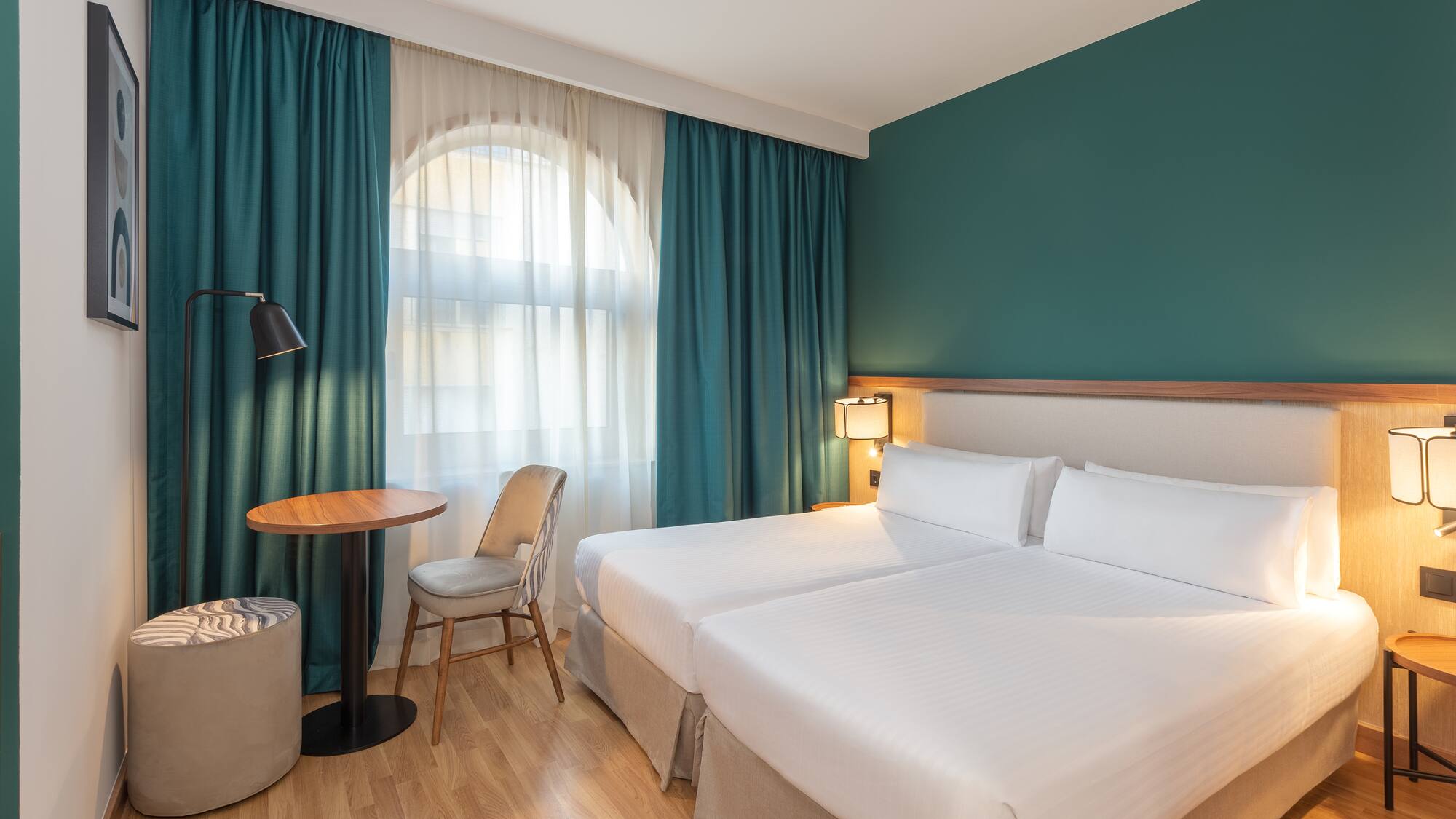 a hotel room with a table and chairs