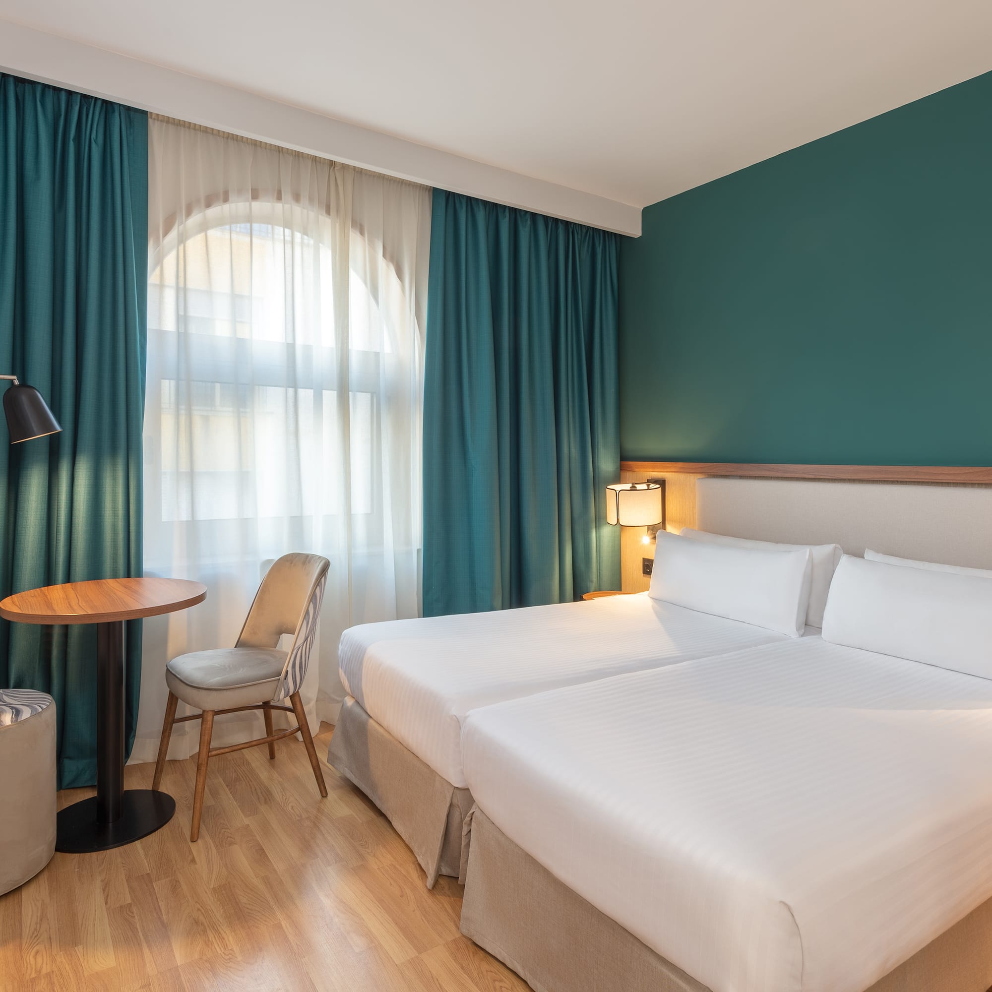 a hotel room with a table and chairs