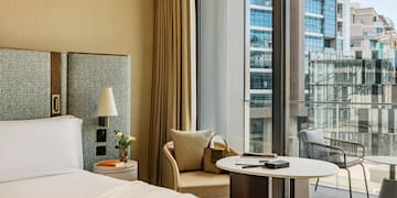 a hotel room with a window and a bed