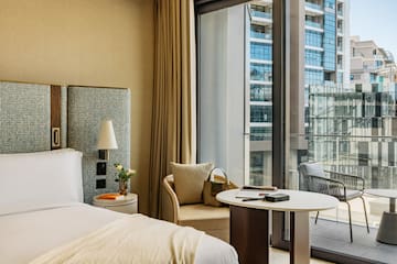 a hotel room with a window and a bed