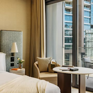 a hotel room with a window and a bed