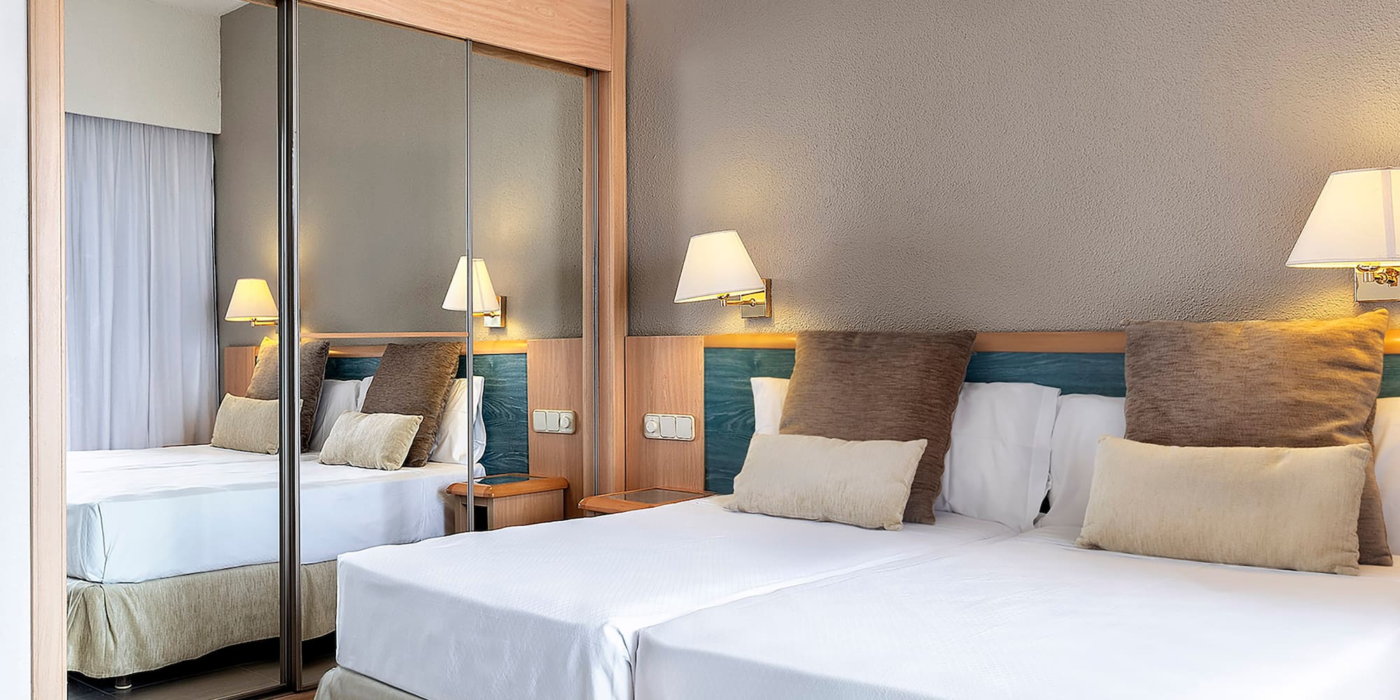 a bed with a mirror in the corner