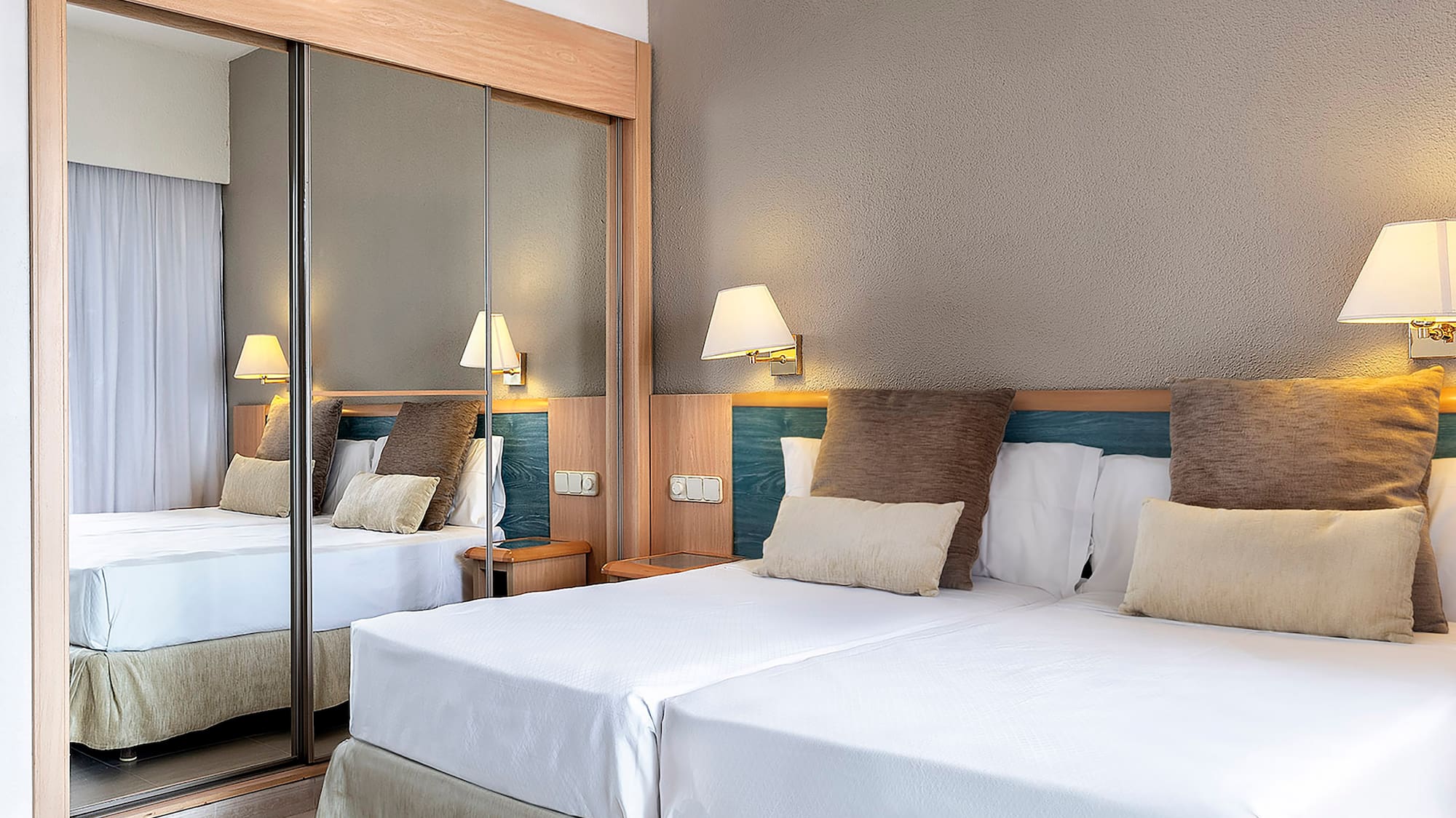 a bed with a mirror in the corner