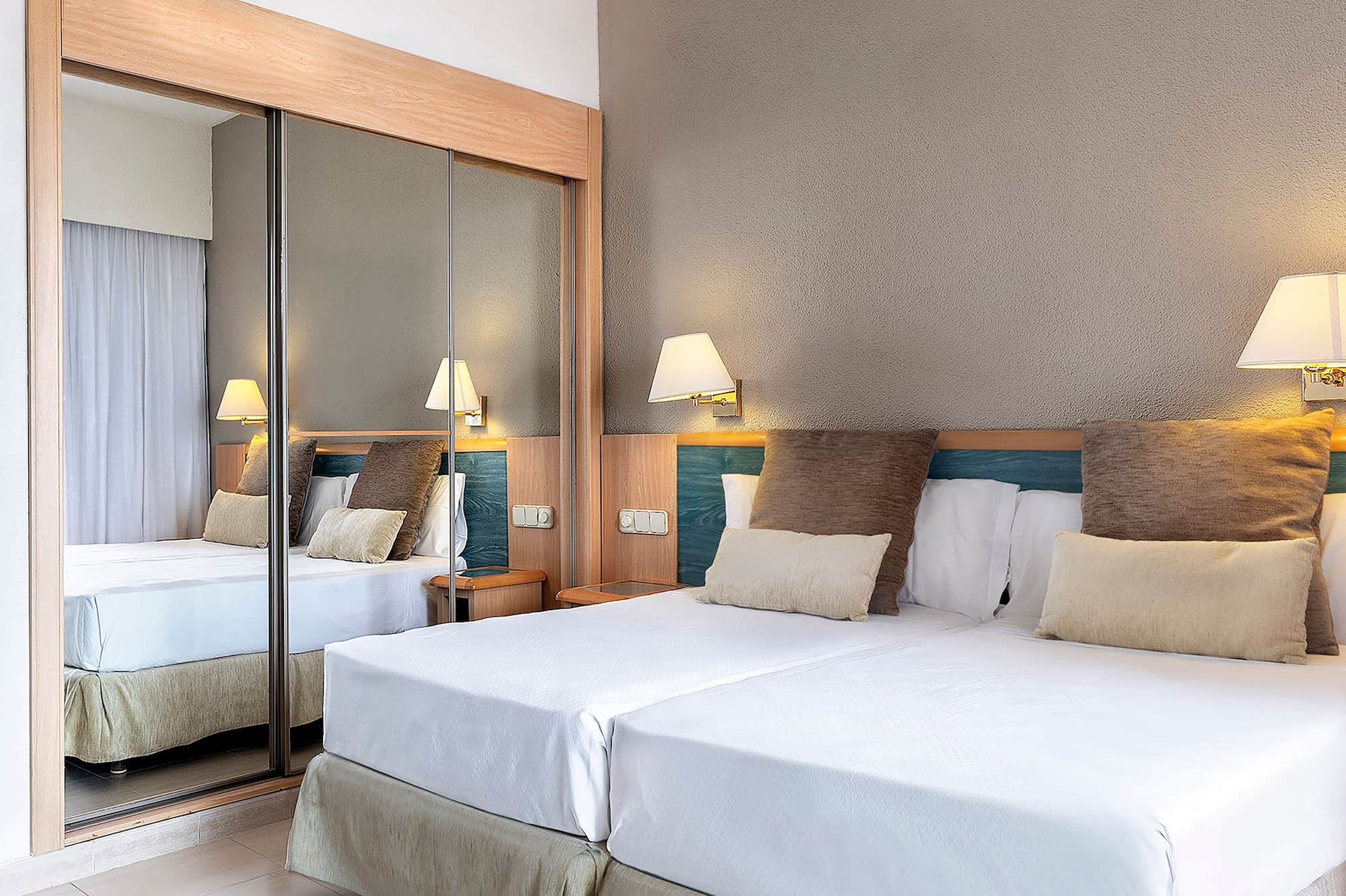 a bed with a mirror in the corner