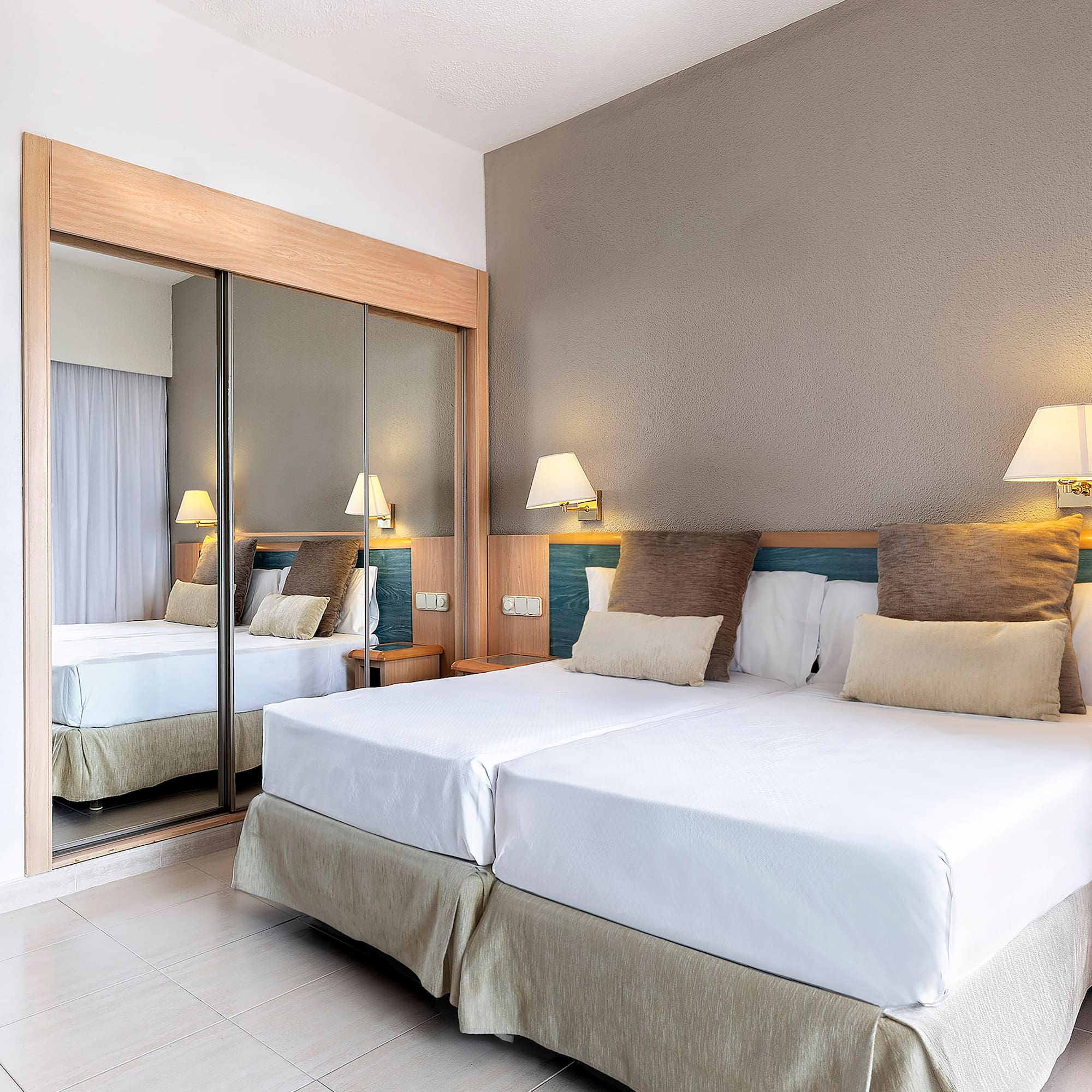 a bed with a mirror in the corner